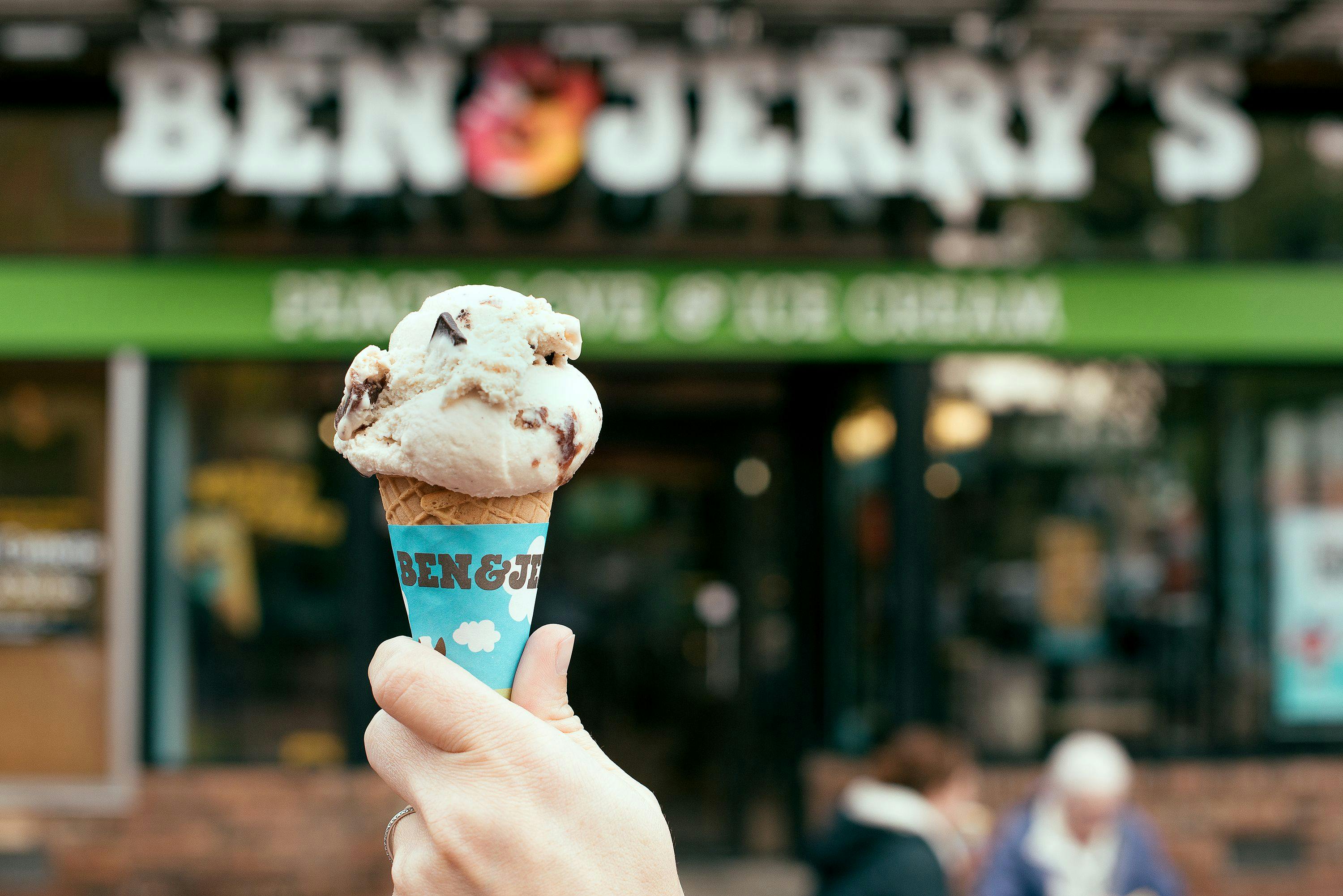 A Ben & Jerry's ice cream cones in front of a local scoop shop