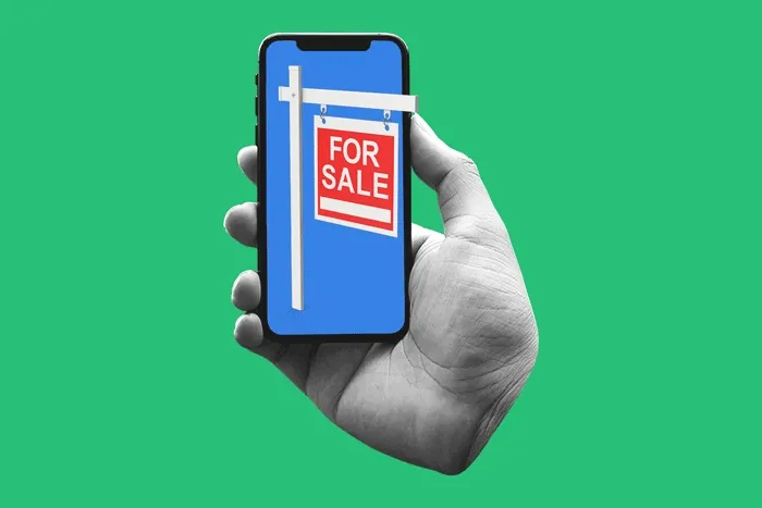 Hand holding phone with an animated 'For Sale' sign